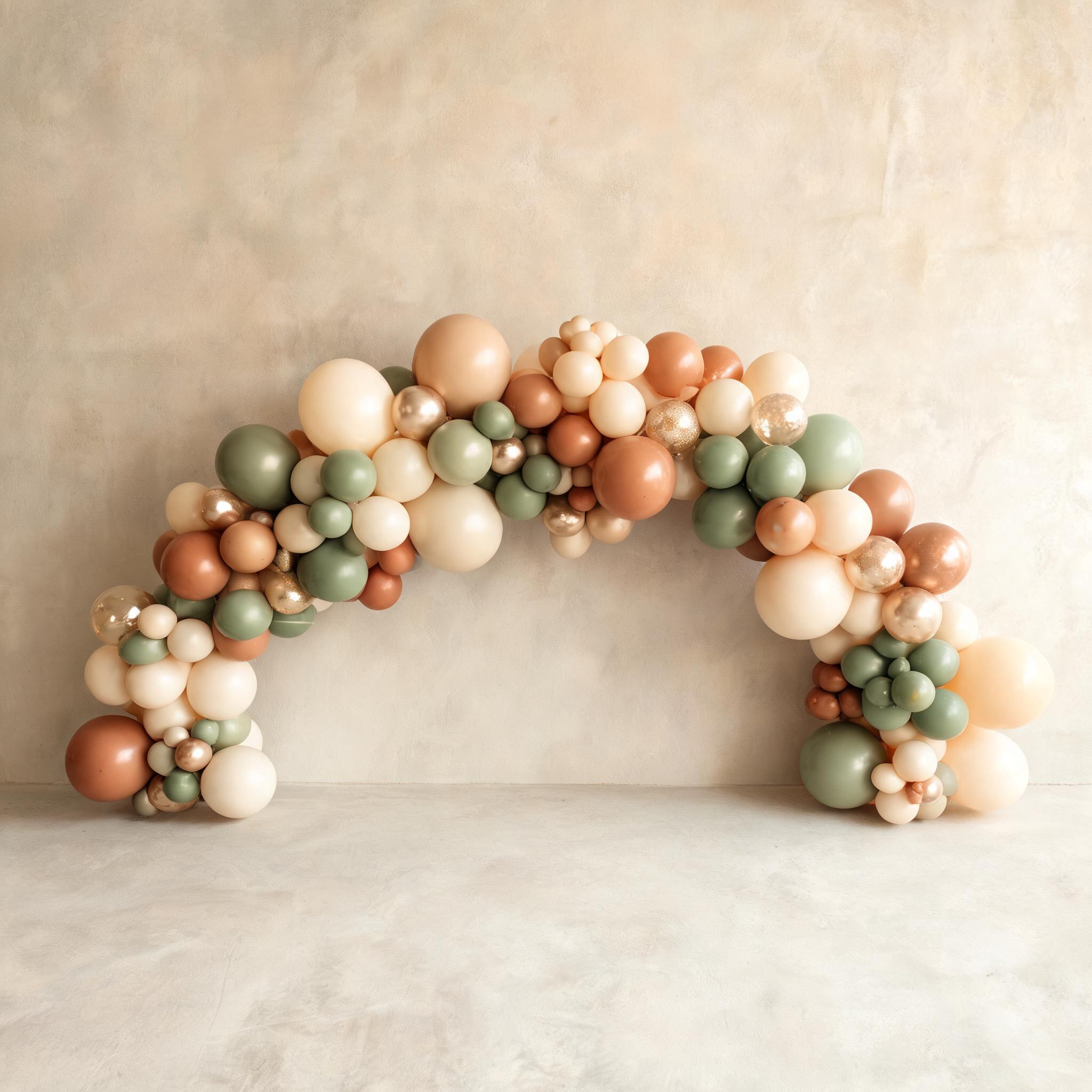 Organic balloon garland arch in muted cream, sage and terracotta tones